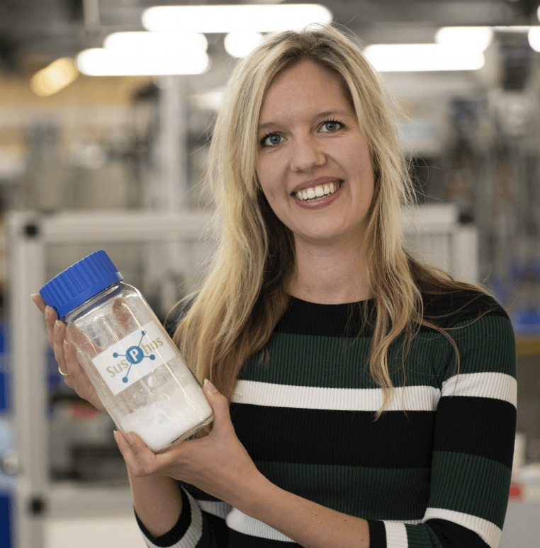 woman-holding-and-presenting-a-jar-filled-with-powdered-substance